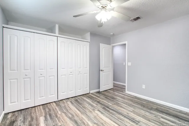 a bathroom with a granite countertop sink a toilet and shower
