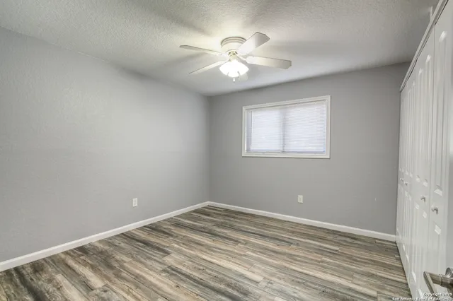wooden floor in an empty room with a window