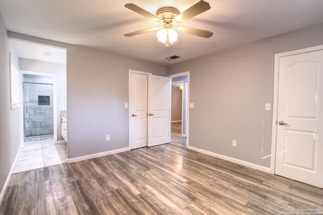a view of empty room with wooden floor