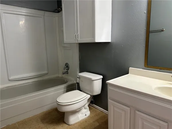 a bathroom with a toilet a sink and bathtub