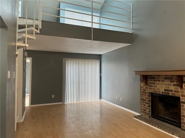 a view of an empty room with a fireplace