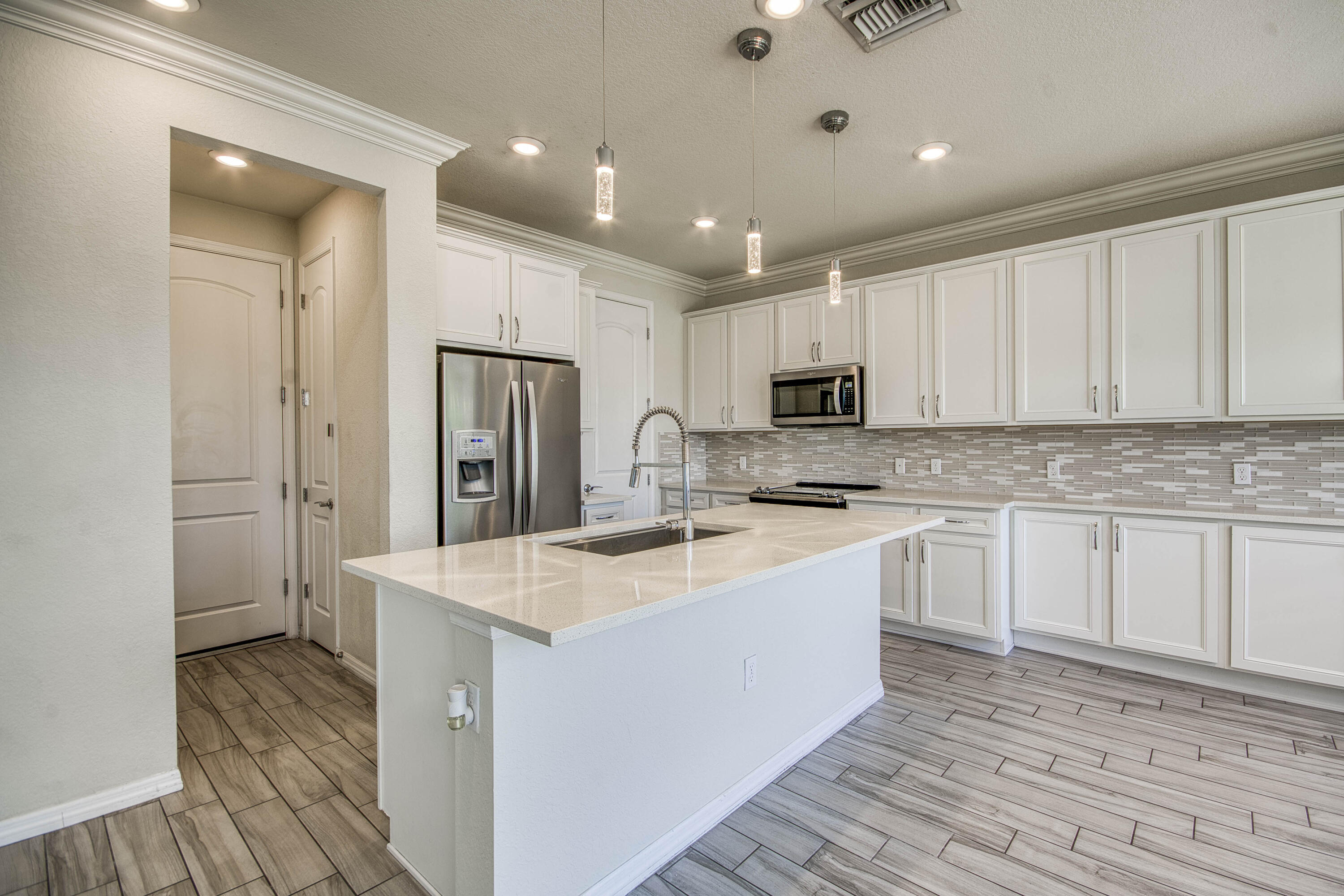 8301 Rearing Lane Lake Worth, FL 33467 - Photo 12 of 33 a kitchen with stainless steel appliances granite countertop a sink stove and refrigerator