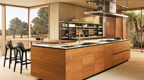 a kitchen with stainless steel appliances granite countertop a sink and a refrigerator