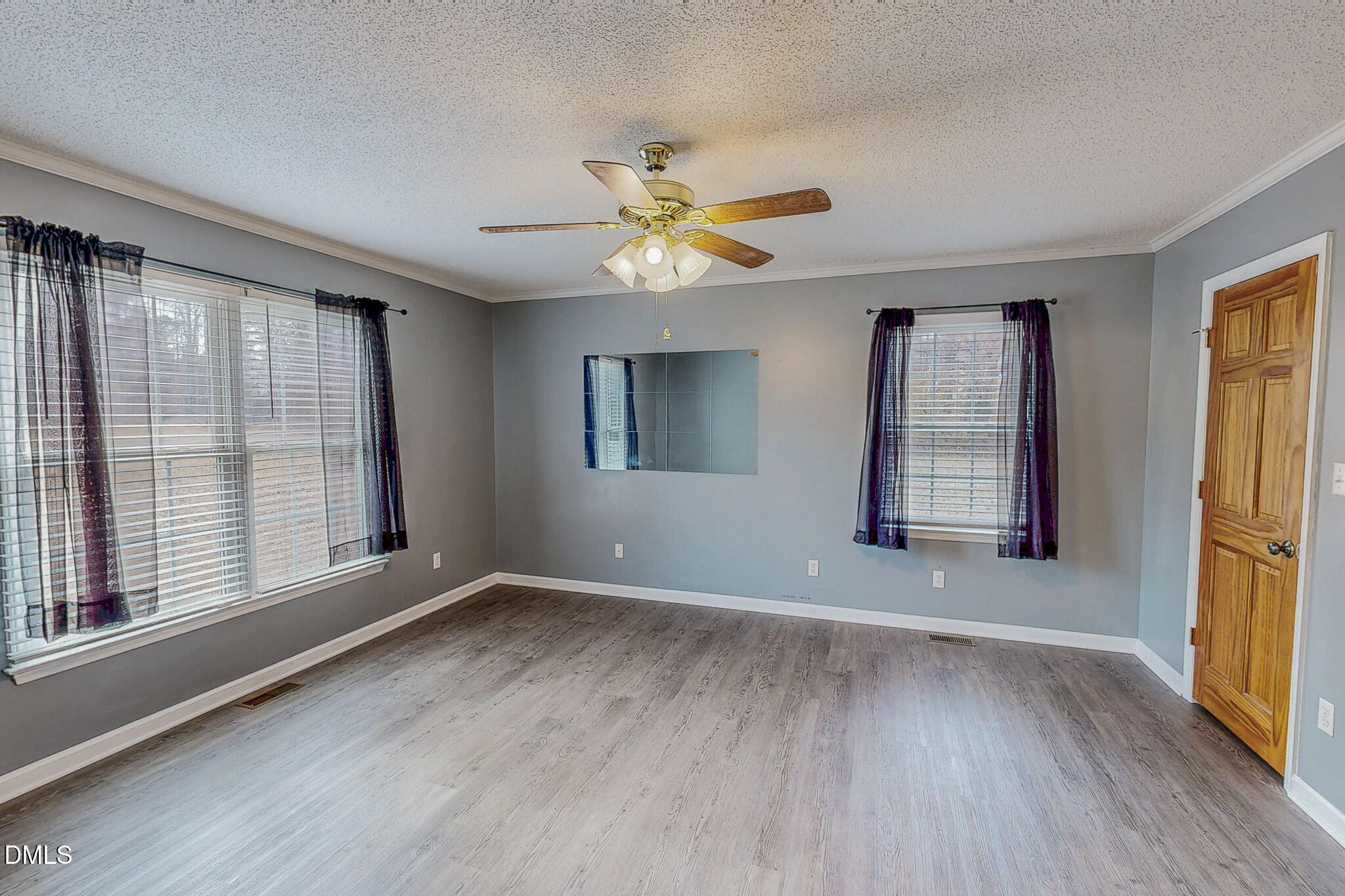 111 Fox Crossing Drive Roxboro, NC 27574 - Photo 14 of 25 an empty room with wooden floor and windows