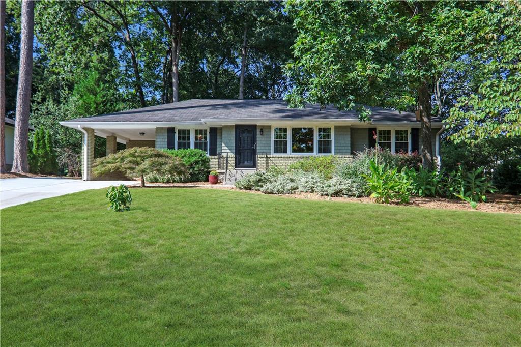 a front view of a house with a garden