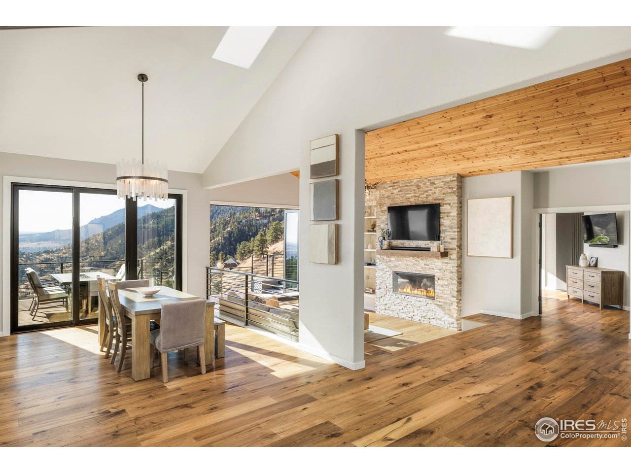 150 Valley View Way Boulder, CO 80304 - Photo 13 of 36 The real focal point lives straight ahead, where massive glass doors open to the deck and Flatirons beyond.