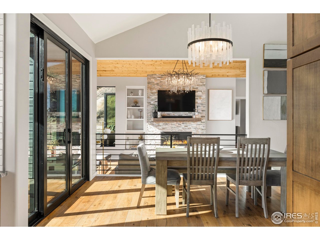 150 Valley View Way Boulder, CO 80304 - Photo 18 of 36 The dining area continues beneath vaulted ceilings and skylights, with sliders leading outside.