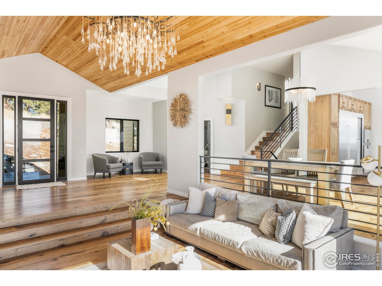 150 Valley View Way Boulder, CO 80304 - Photo 18 of 36 Step down from the entry into a living room defined by soaring ceilings and anchored by a stone-surround gas fireplace.