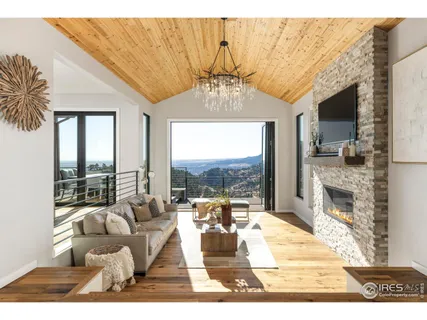 a living room with fireplace furniture and a floor to ceiling window