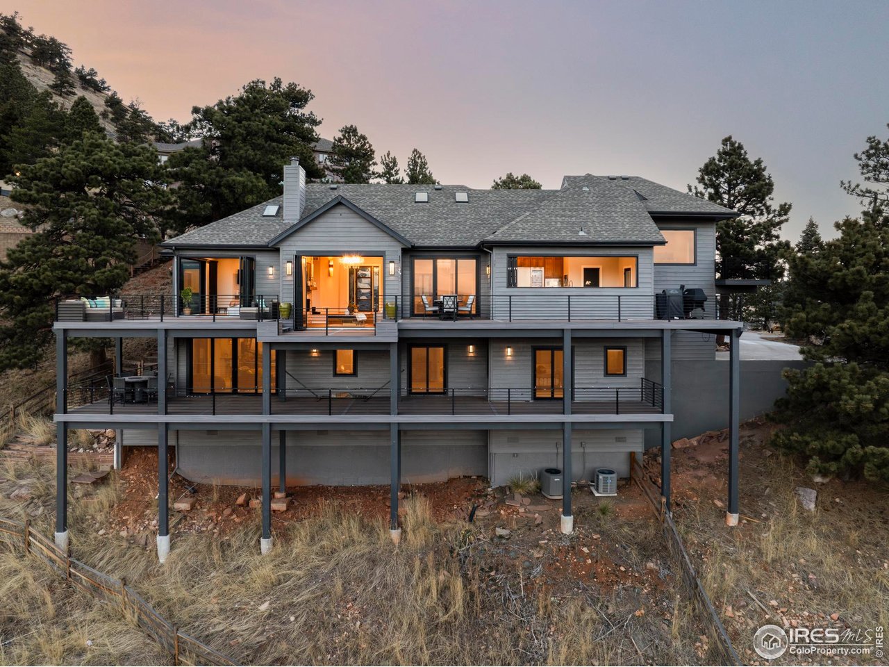 150 Valley View Way Boulder, CO 80304 - Photo 35 of 36 Extensive wrap-around decks span multiple levels with custom metal railings that preserve sightlines, creating true outdoor rooms accessible from nearly every space.