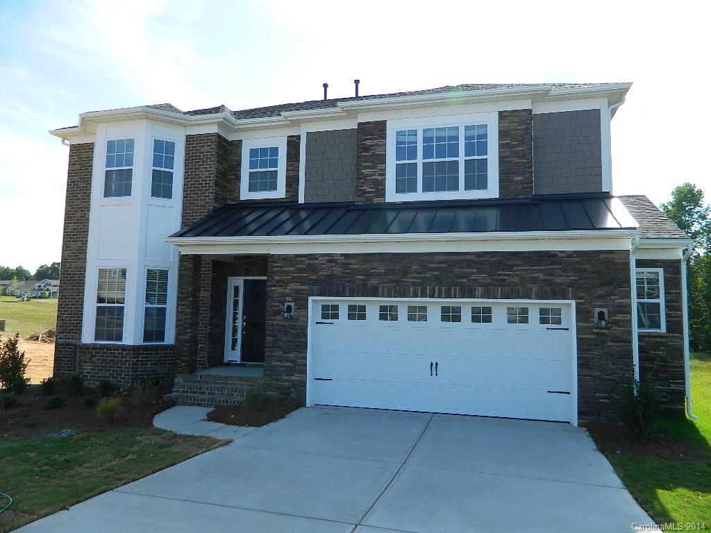 505 Brookhaven Drive, Unit HC82 Fort Mill, SC 29708 - Photo 1 of 9 a front view of a house with a yard and garage