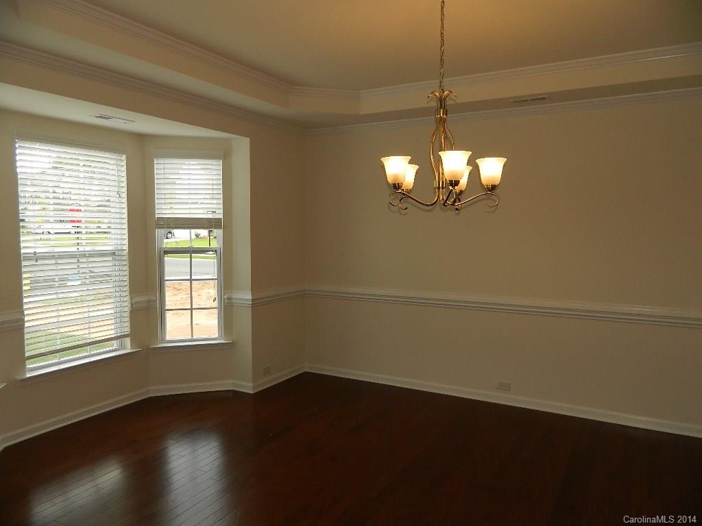 505 Brookhaven Drive, Unit HC82 Fort Mill, SC 29708 - Photo 3 of 9 an empty room with wooden floor and windows
