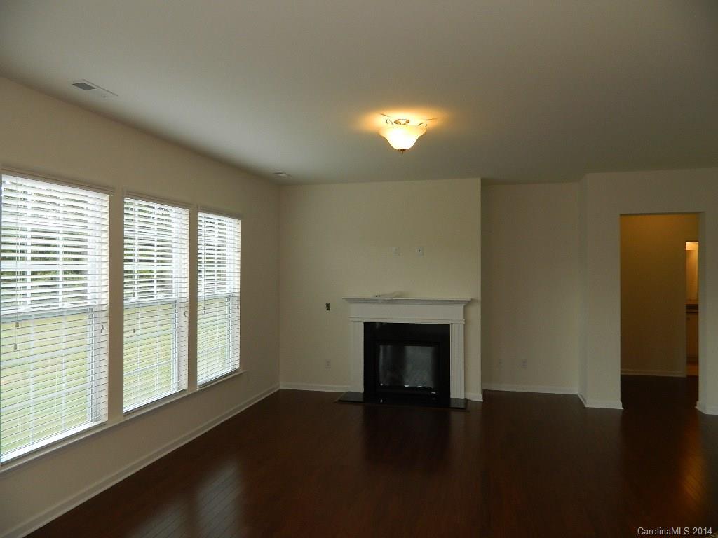 505 Brookhaven Drive, Unit HC82 Fort Mill, SC 29708 - Photo 4 of 9 a view of an empty room with wooden floor and a window