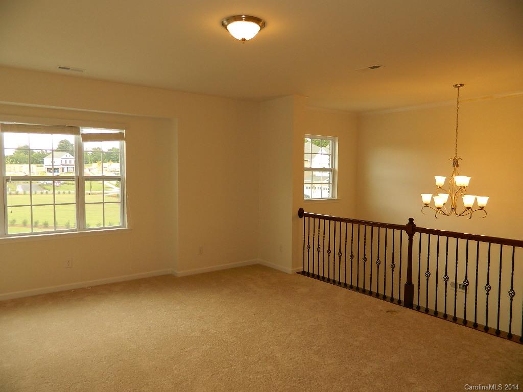 505 Brookhaven Drive, Unit HC82 Fort Mill, SC 29708 - Photo 7 of 9 a view of an empty room with window and chandelier fan