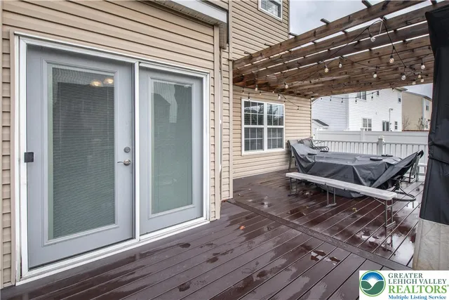 a kitchen with stainless steel appliances granite countertop a refrigerator a sink dishwasher a stove and white cabinets with wooden floor