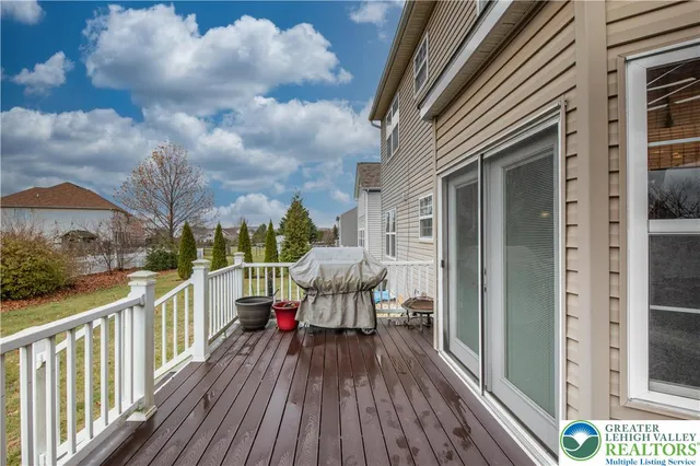 a kitchen with granite countertop a stove a sink dishwasher a dining table and chairs with wooden floor