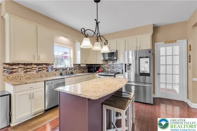 a view of hallway with wooden floor and staircase