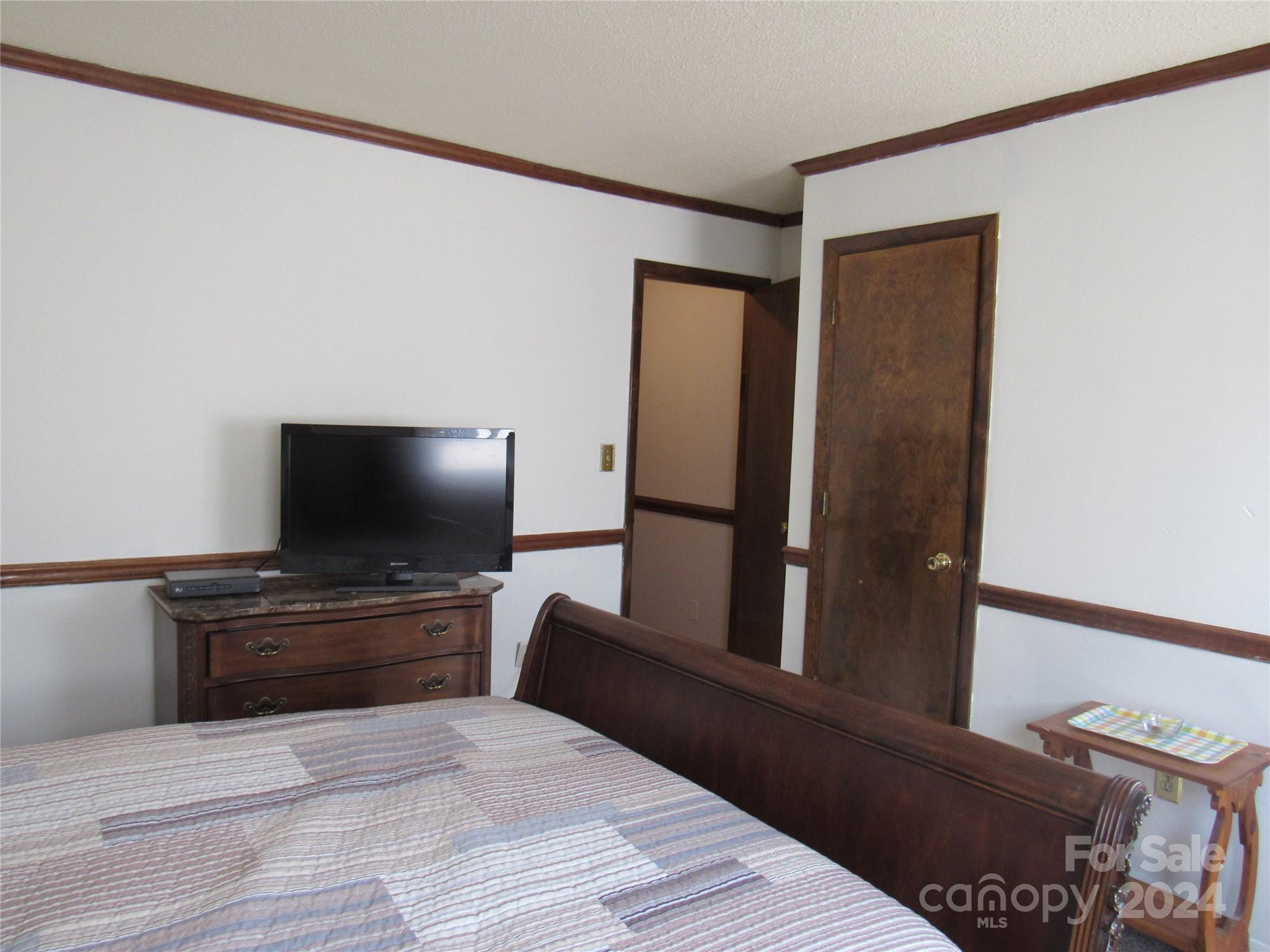 171 Fox Run Road Forest City, NC 28043 - Photo 19 of 32 a bedroom with a bed and a flat screen tv