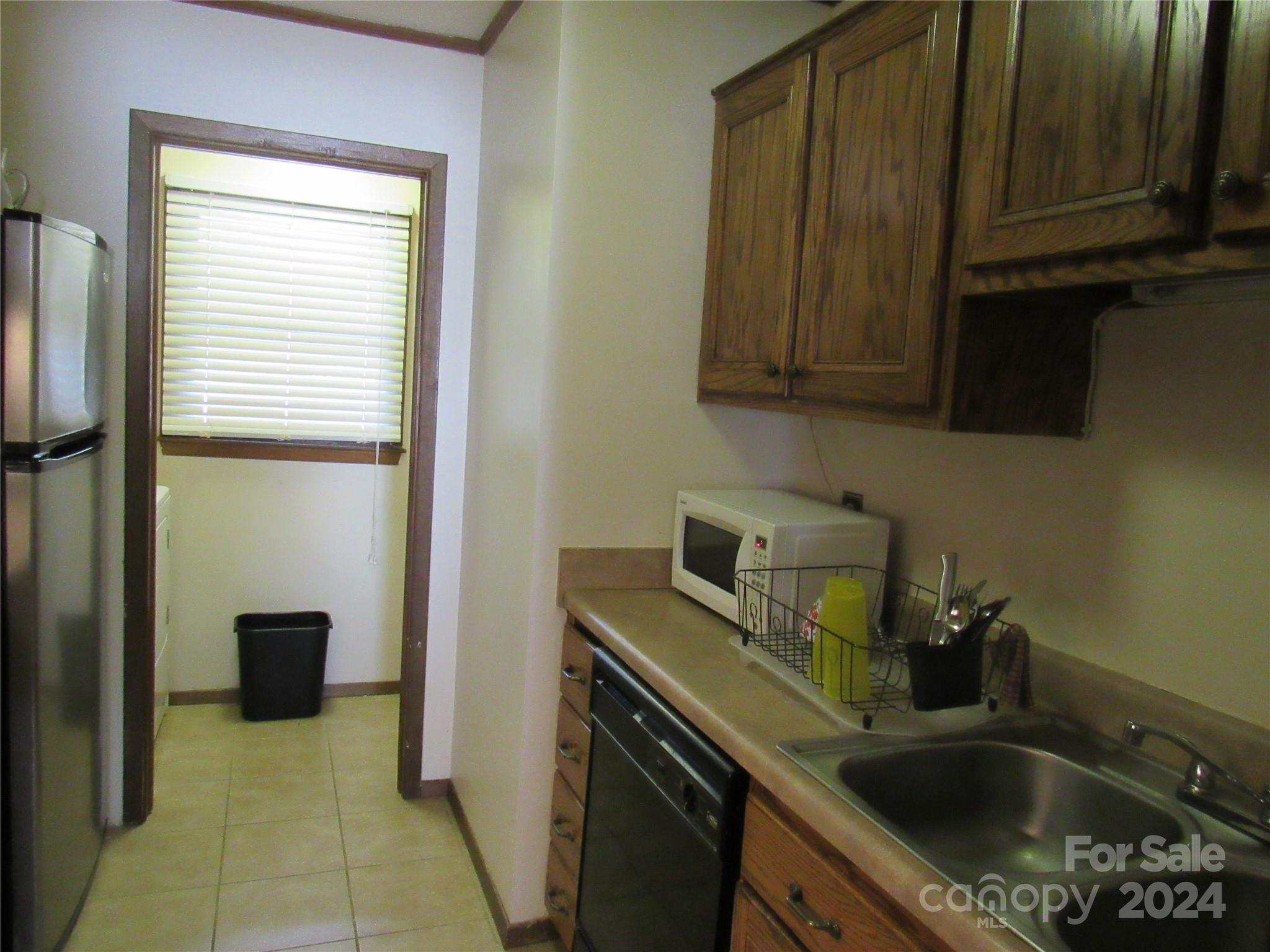 171 Fox Run Road Forest City, NC 28043 - Photo 6 of 32 a kitchen with a sink a stove and a refrigerator