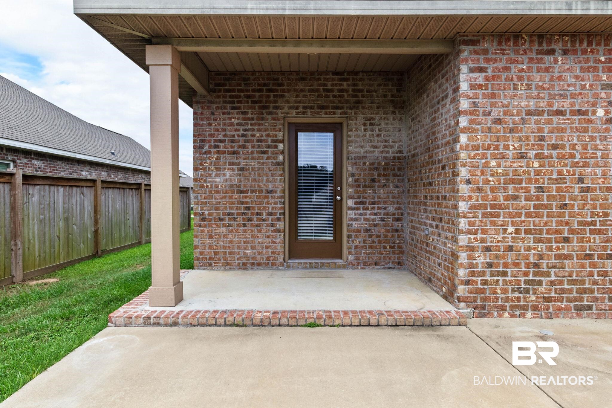 1710 Grouse Street Foley, AL 36535 - Photo 72 of 76 Covered patio featuring a brick exterior, concrete flooring, and a wood-paneled ceiling