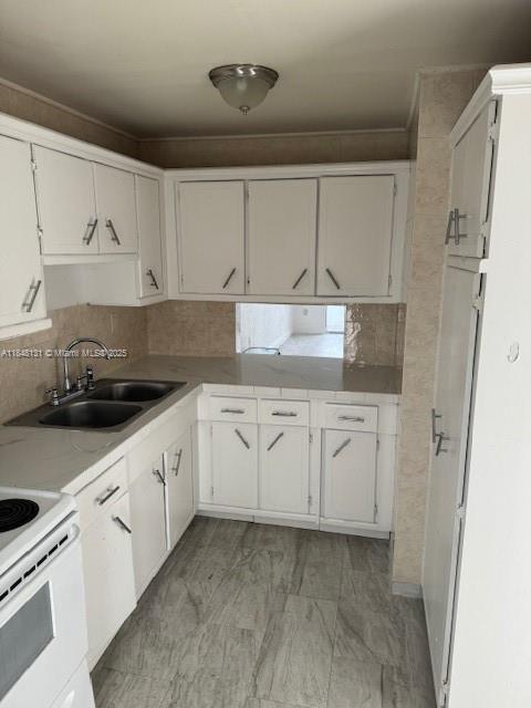 1850 Northeast 169th Street, Unit 308 North Miami Beach, FL 33162 - Photo 19 of 29 a kitchen with granite countertop white cabinets and white appliances