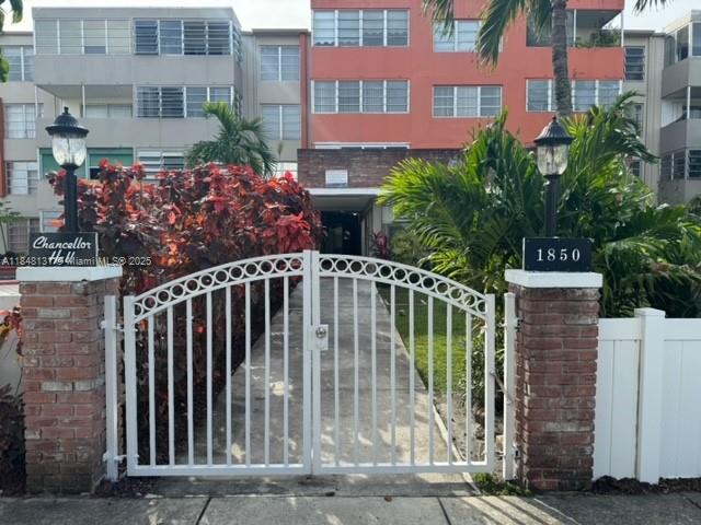 1850 Northeast 169th Street, Unit 308 North Miami Beach, FL 33162 - Photo 2 of 29 a view of a brick house with plants and a small yard