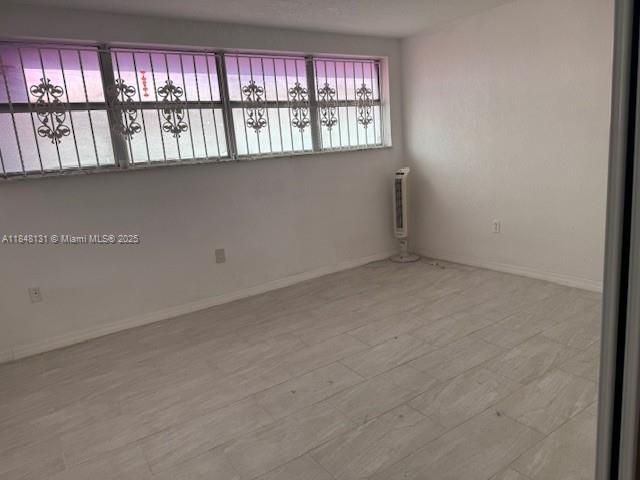 1850 Northeast 169th Street, Unit 308 North Miami Beach, FL 33162 - Photo 22 of 29 a view of an empty room with wooden floor