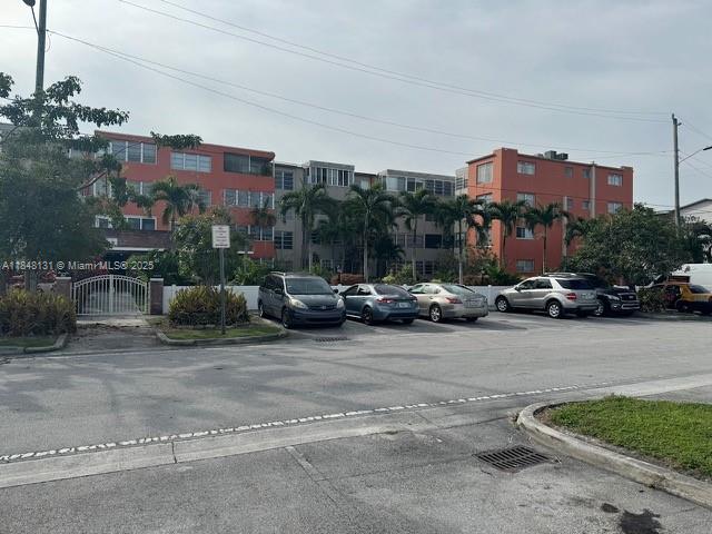 1850 Northeast 169th Street, Unit 308 North Miami Beach, FL 33162 - Photo 3 of 29 a view of a cars park in front of a building