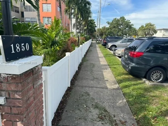 a view of a pathway with house on side of the road