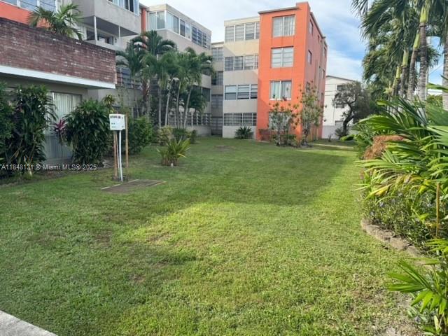 1850 Northeast 169th Street, Unit 308 North Miami Beach, FL 33162 - Photo 6 of 29 a garden with trees in front of it