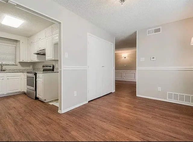 a view of a kitchen with a sink and a refrigerator