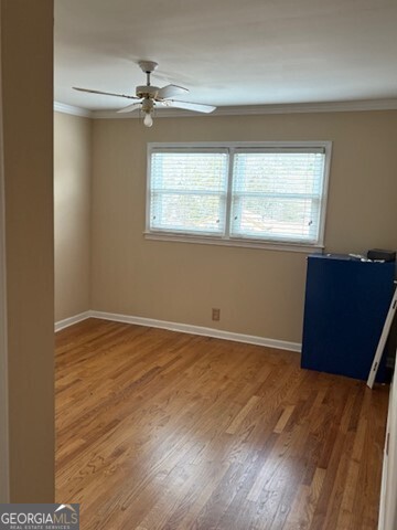 3419 Columbia Court Decatur, GA 30032 - Photo 5 of 17 an empty room with wooden floor and windows