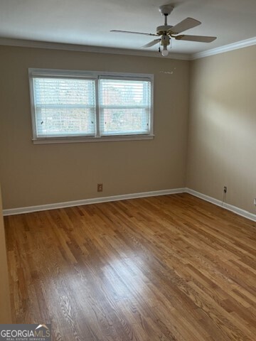 3419 Columbia Court Decatur, GA 30032 - Photo 6 of 17 a view of an empty room with wooden floor and a window