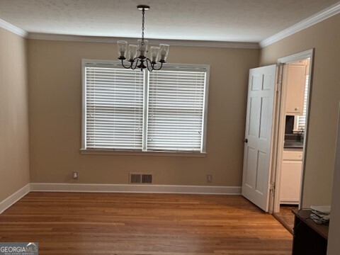 3419 Columbia Court Decatur, GA 30032 - Photo 9 of 17 a view of an empty room with window and wooden floor