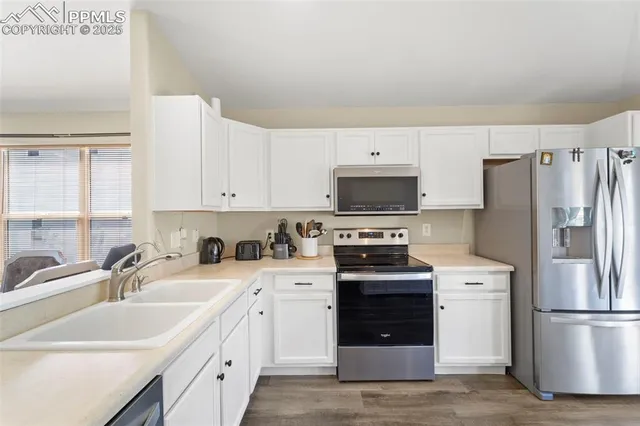 a kitchen with a sink white stove and refrigerator