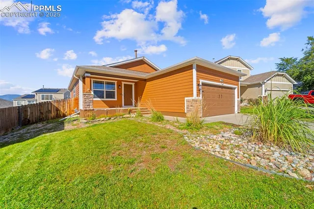 a front view of a house with a yard