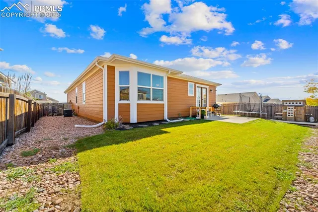 a swimming pool with outdoor seating and yard