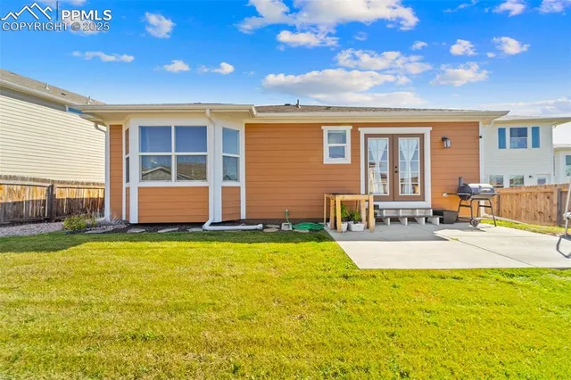 an aerial view of a house with a yard