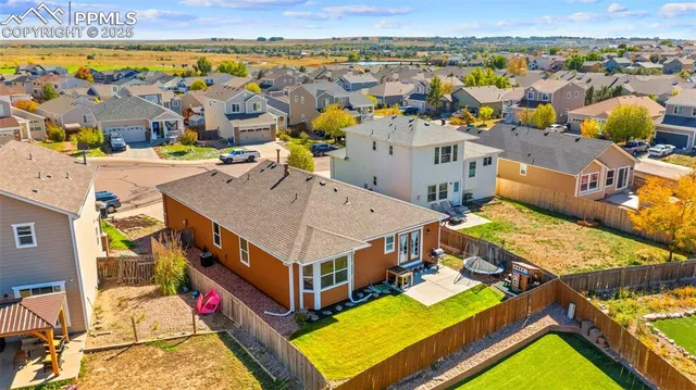 a aerial view of a house with swimming pool lawn chairs and ocean view