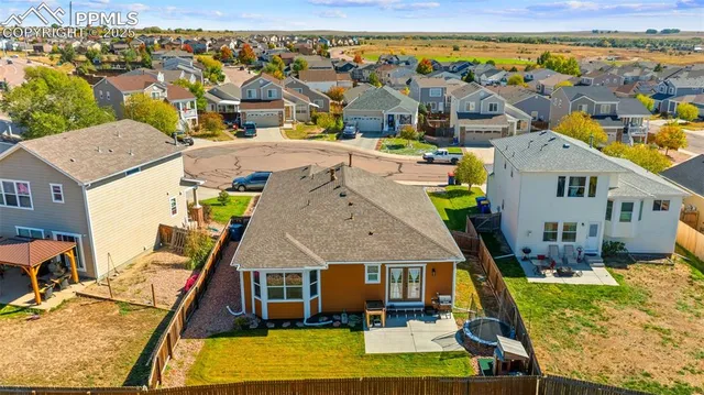 an aerial view of residential houses with outdoor space and ocean view