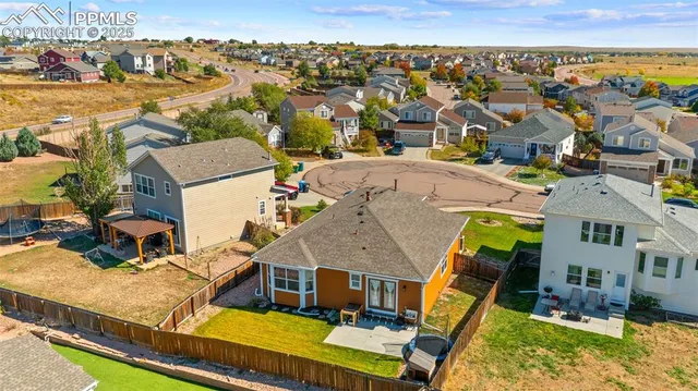 an aerial view of a house with a swimming pool