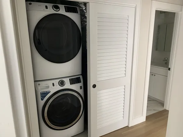 a view of a hallway with washer and dryer