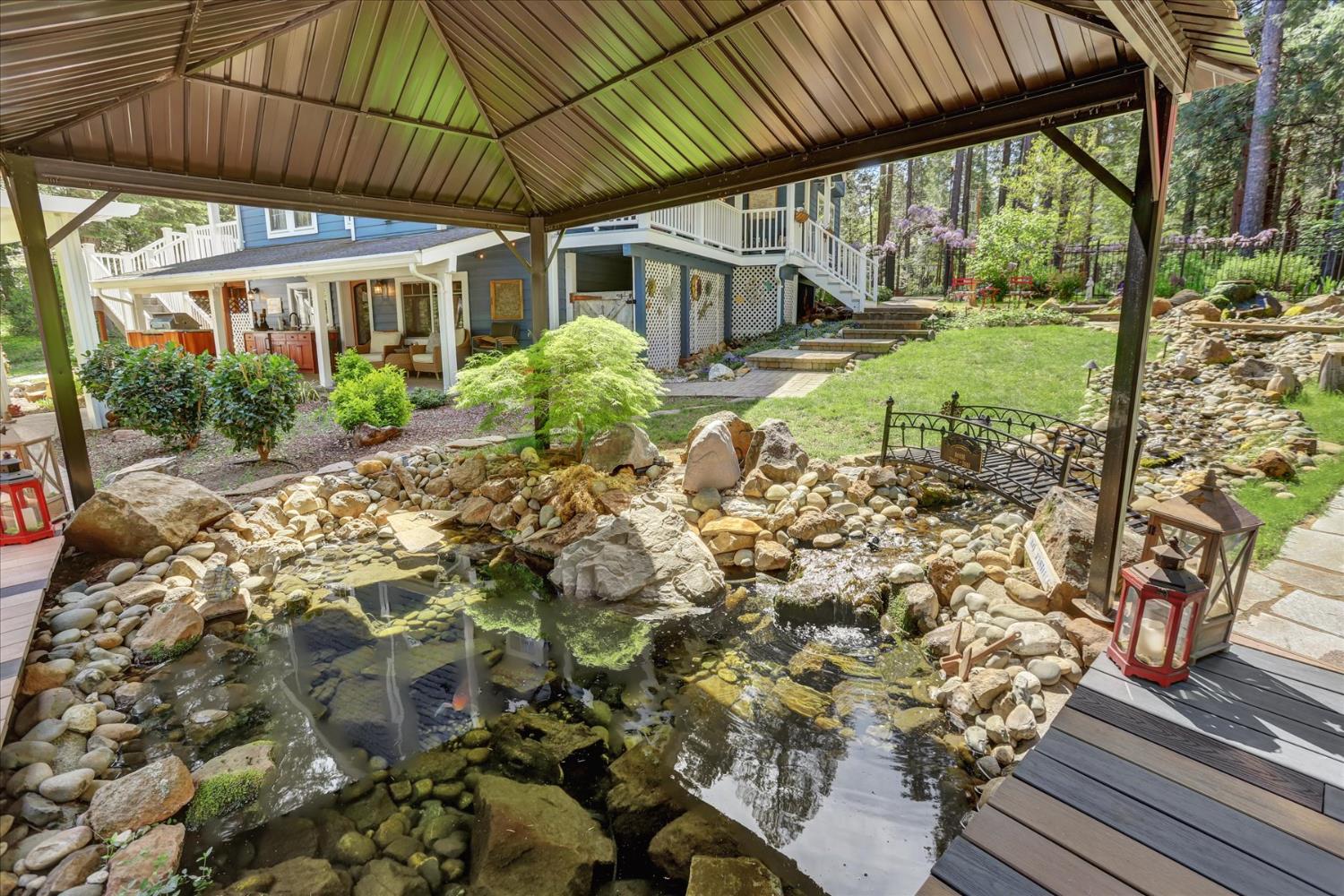 19793 Scotts Flat Road Nevada City, CA 95959 - Photo 37 of 50 a view of a patio with table and chairs under an umbrella