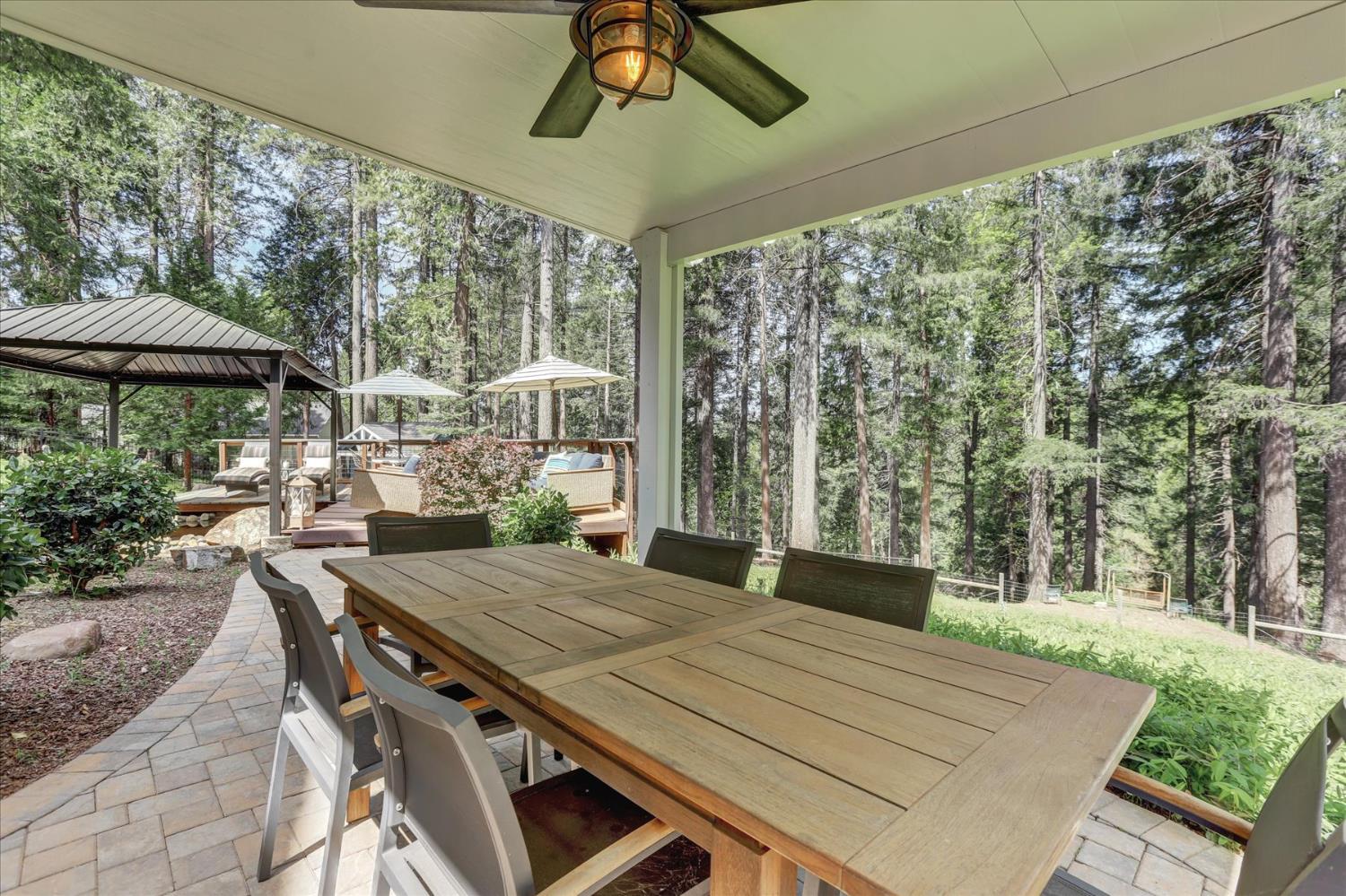 19793 Scotts Flat Road Nevada City, CA 95959 - Photo 39 of 50 a view of a patio with a table chairs and a backyard