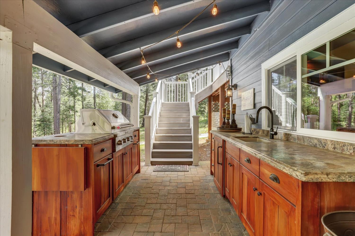 19793 Scotts Flat Road Nevada City, CA 95959 - Photo 41 of 50 a kitchen with granite countertop a sink and wooden cabinets