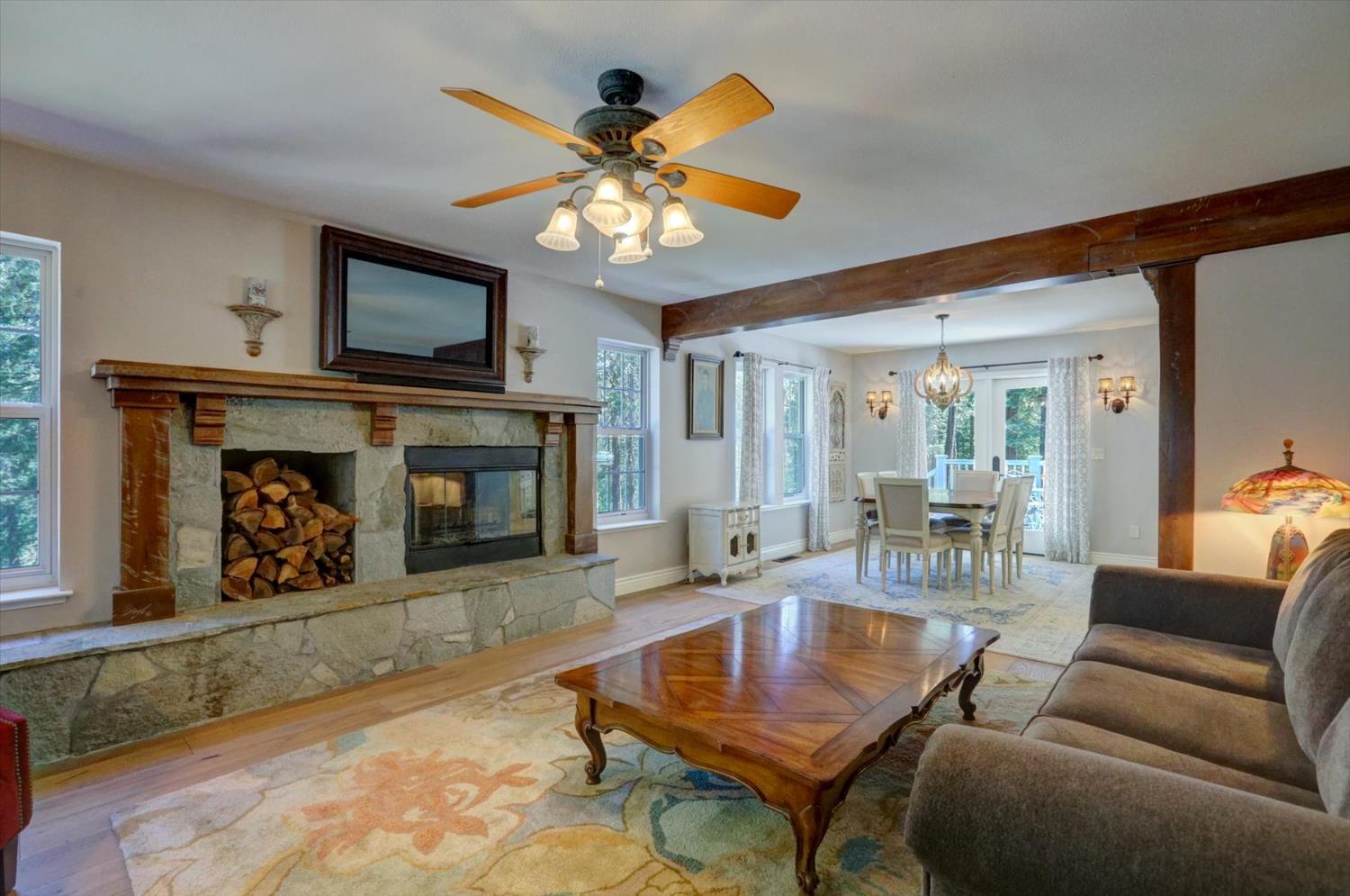 19793 Scotts Flat Road Nevada City, CA 95959 - Photo 8 of 50 a living room with furniture a flat screen tv and a fireplace
