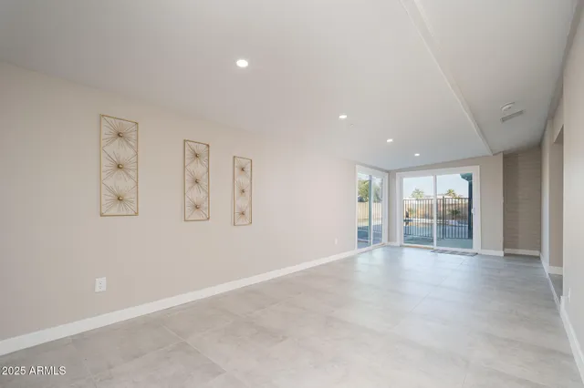 an empty room with windows and closet