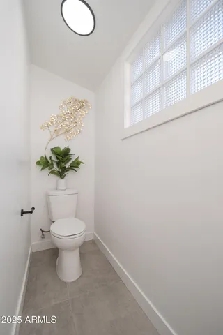 a white toilet sitting next to a bathroom sink