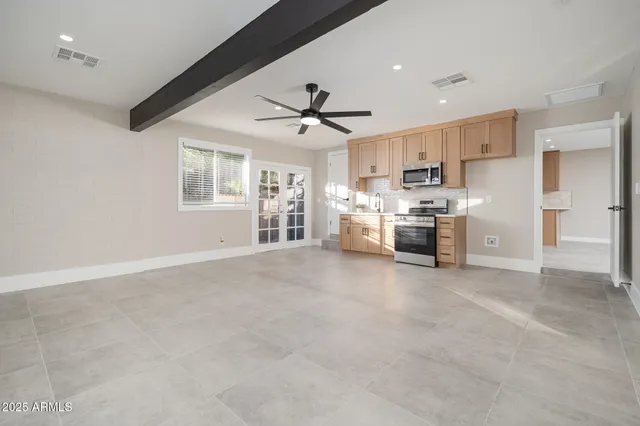 a view of a kitchen with a stove cabinets and a ceiling fan