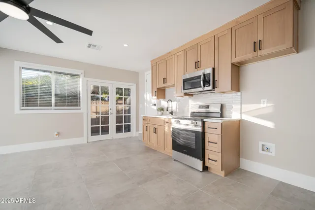 a kitchen with stainless steel appliances granite countertop a stove and a sink